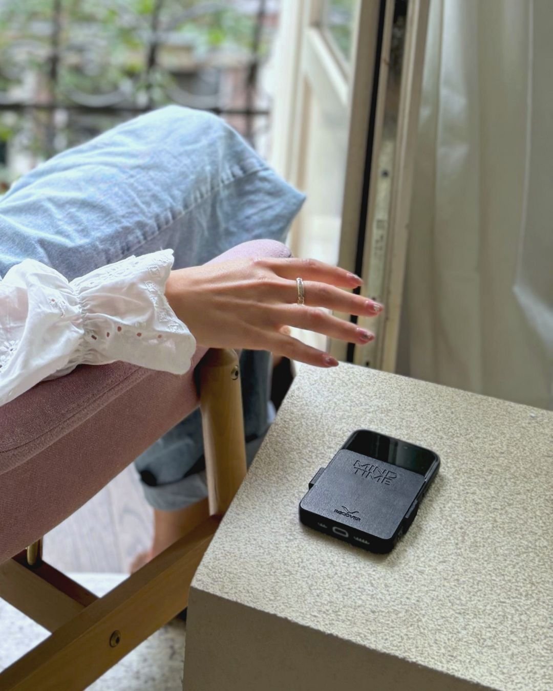 Putting the phone aside on the table, by the window