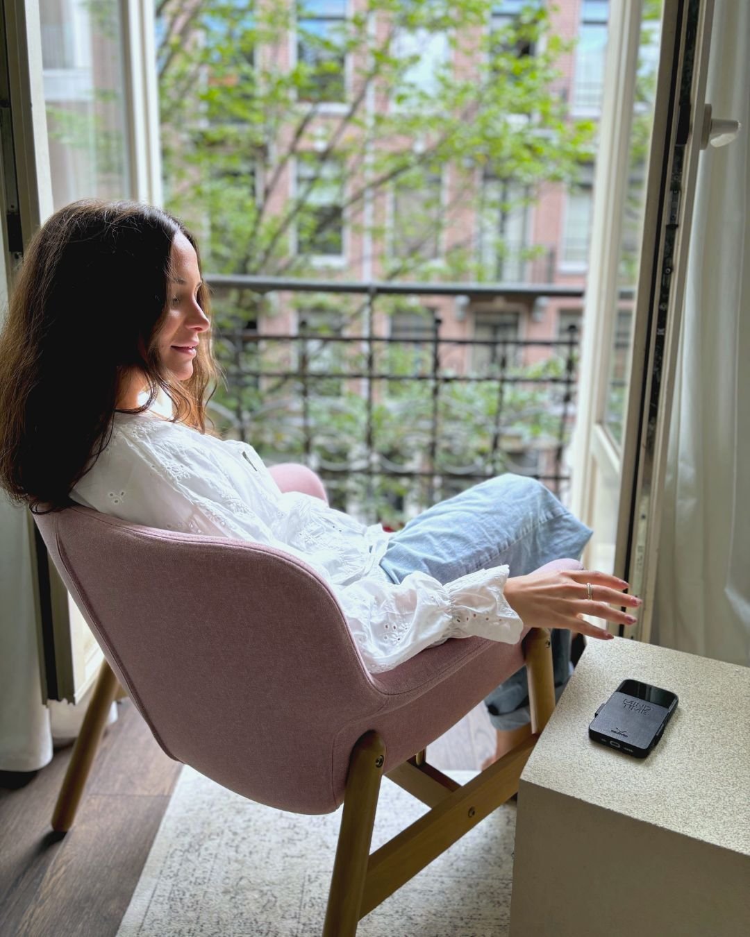 Relaxing by the window, phone set aside
